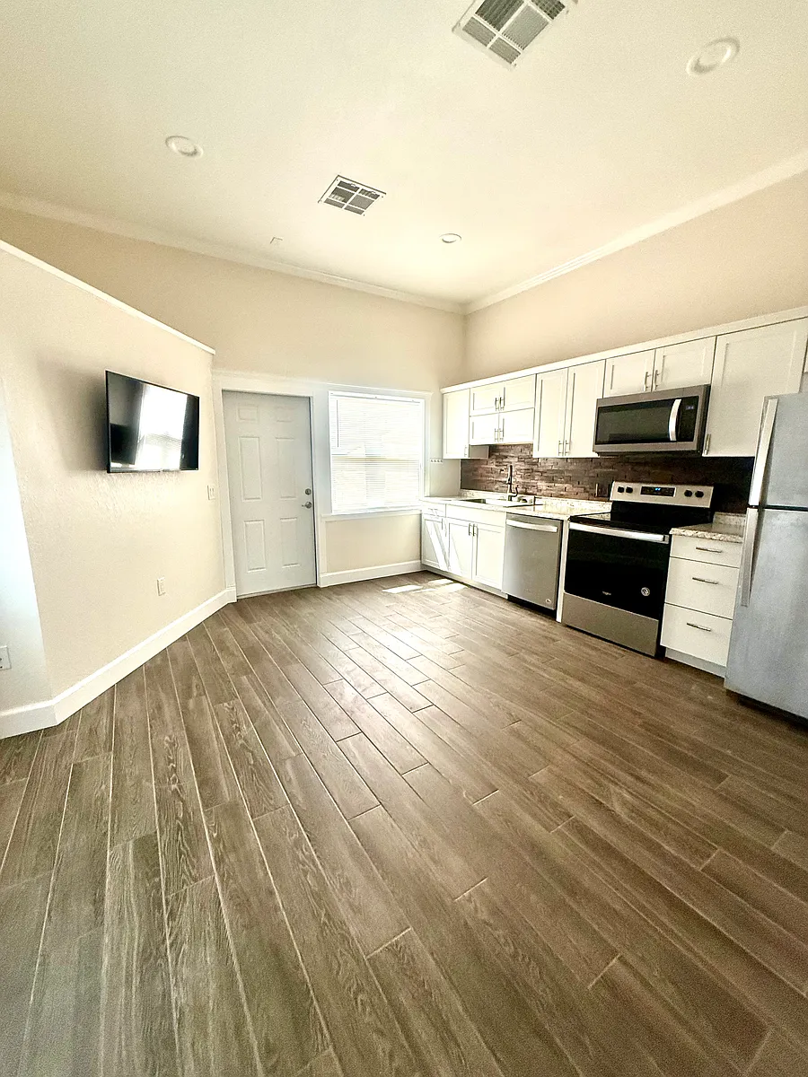 Full kitchen and living area - 100 61st St E #2