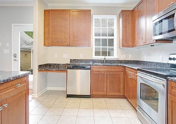 Kitchen with granite and stainless steel, tile floor. Backdoor.