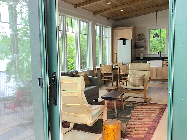 view into cottage from lake-side deck