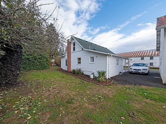 Southwest corner of the house with view of the back garden and heirloom apple tree.
