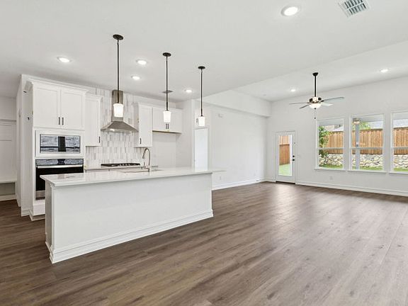Spacious eat-in kitchen designed with a large island for dining Real home pictured