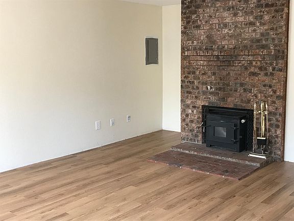 living room with wood burning fireplace