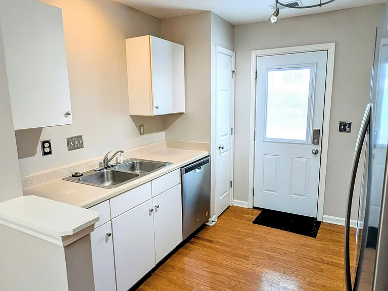 Kitchen with Stainless steel appliances. Exit to back parking area