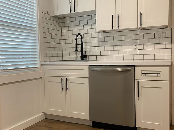 Newly remodeled kitchen, with subway tile backsplash and stainless steel dishwasher