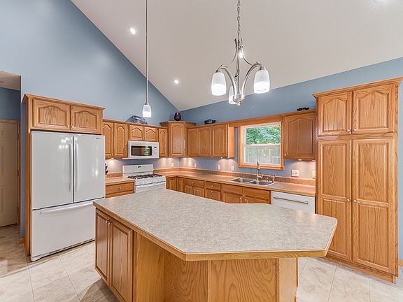 The island kitchen has updated appliances and plenty of counter space.
