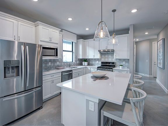 Kitchen with large center island and stainless steel appliances