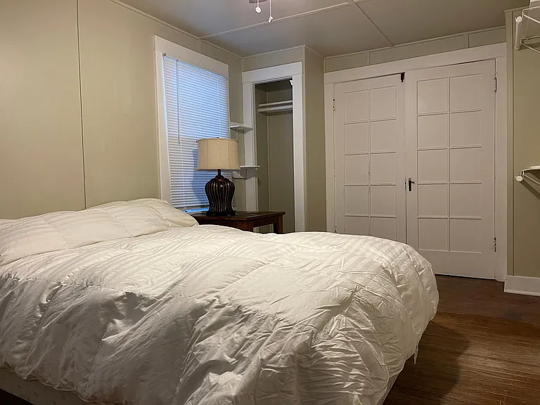 Bedroom with closing doors to living room.