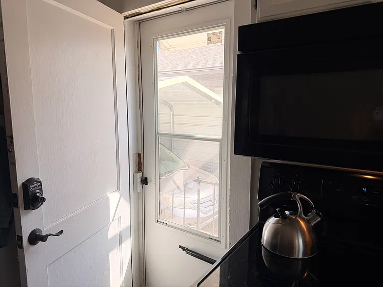 Side door in kitchen leading out to long driveway. Easy to bring groceries to kitchen.