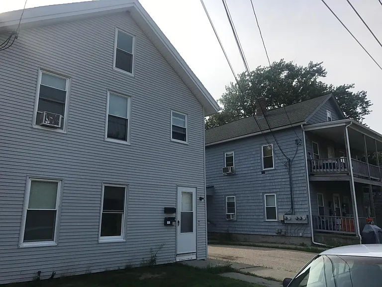 View from the street of both buildings we own, shared driveway between them leads to off-street parking behind 14 Day Lane