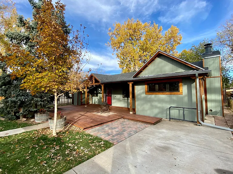 Front of the home with a huge deck and driveway