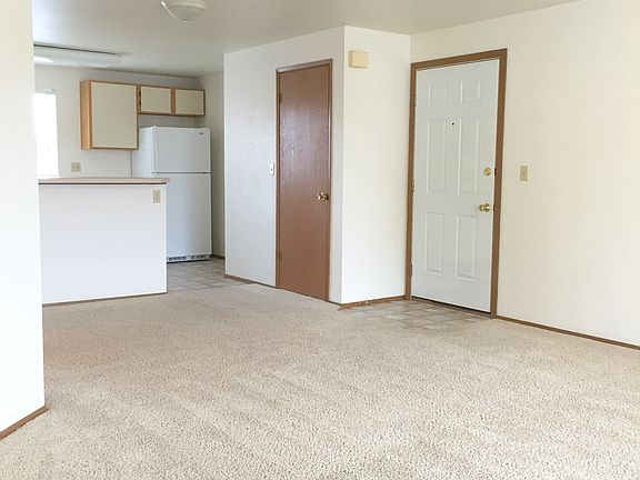 Living room looking toward kitchen and entry.