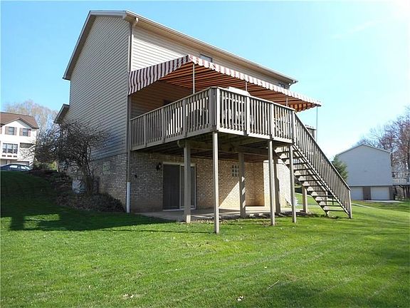 AWNING COVERED DECK. CONCRETE PATIO