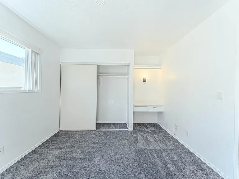 Bedroom with closet and desk space