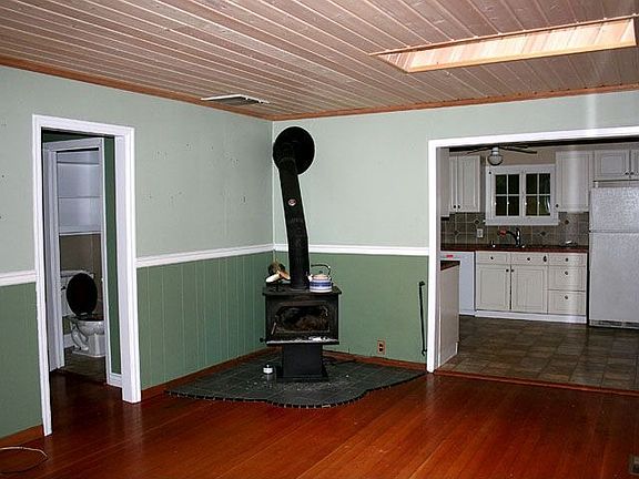 Creative tilework under charming wood stove.