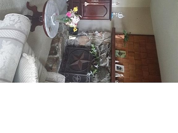 Living room with wood burning stone fireplace