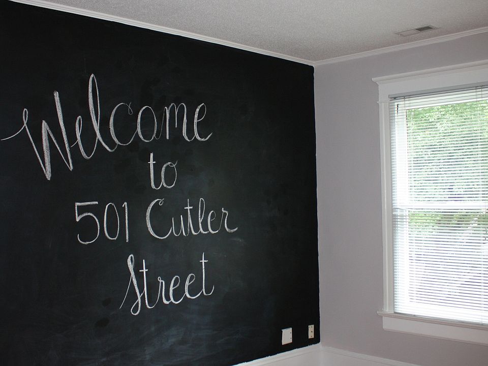 Large living room with chalkboard wall