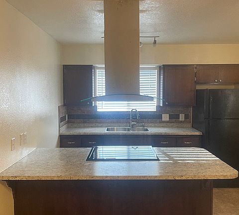Kitchen offers brand new stainless steel electric range, stainless steel sink, range hood and refrigerator included.