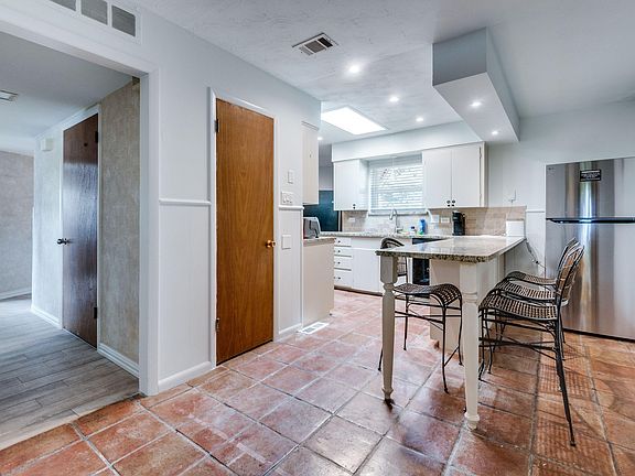 Warm tiles, granite tops, and good vibes this kitchen feels like home