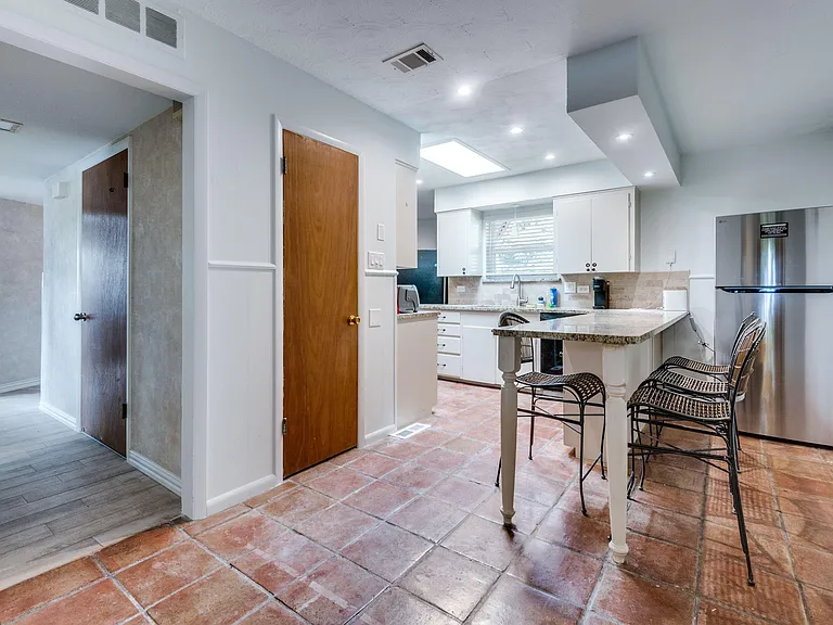 Warm tiles, granite tops, and good vibes this kitchen feels like home