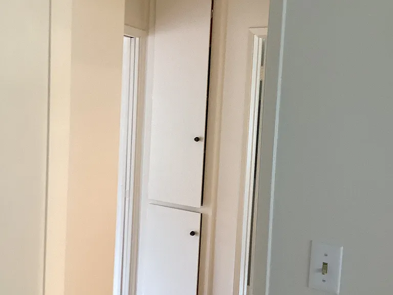 Closet space with lots of shelfs for storage.