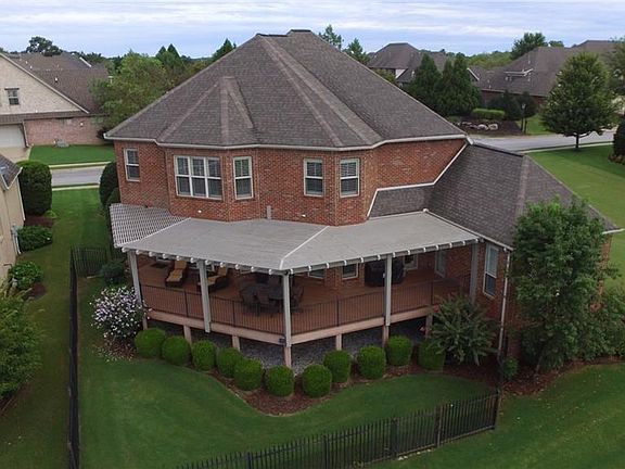 All brick home has pergola that covers entire back deck. Beautifully landscaped with fenced yard. No neighbor on the east side of home.
