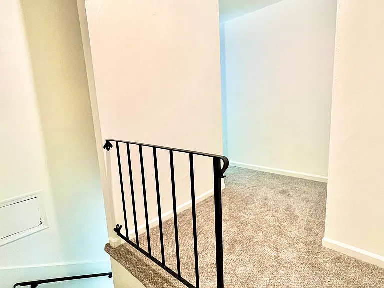 Upstairs hallway leading to Shared full bathroom and two other bedrooms