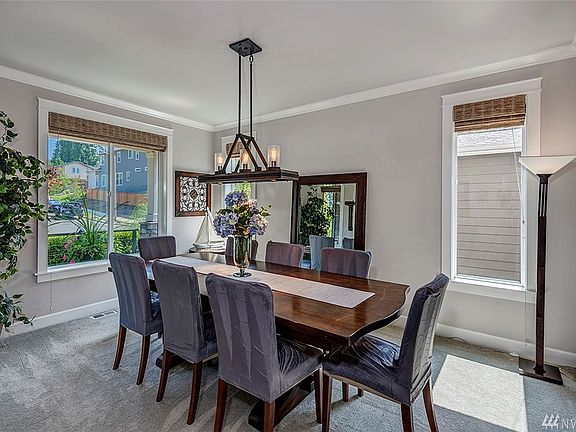 Formal Dining Room Includes Custom Lighting Fixture, Designer Window Blinds, And Crown Molding.