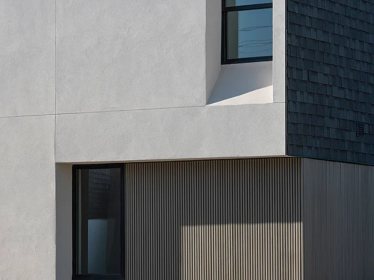 Durable, low-maintenance materials and warm vertical textures create a sophisticated modern exterior with lasting architectural character.