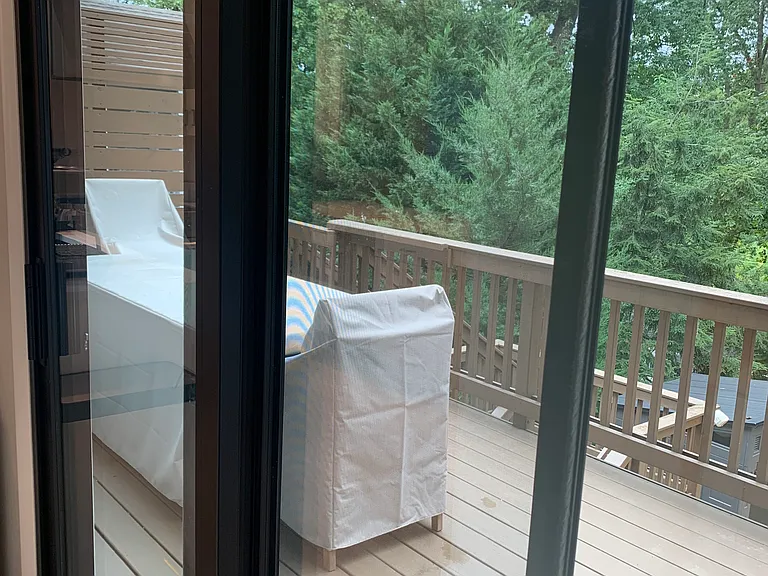 View of new luxury outdoor dining set accessible from two rooms including kitchen and bonus room on main level