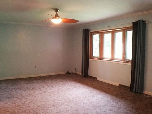 Carpeted LR with large bow window for lots of natural light