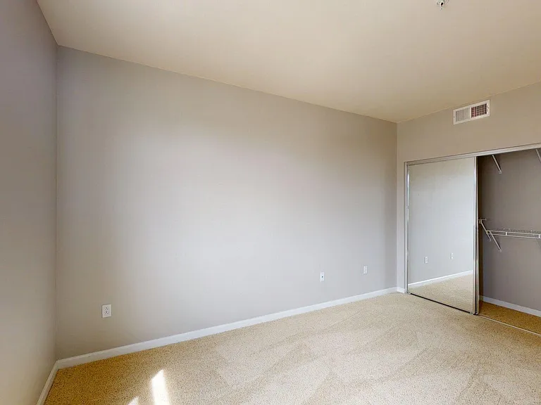 Spacious apartment Bedroom with Large Closet and Carpet.
