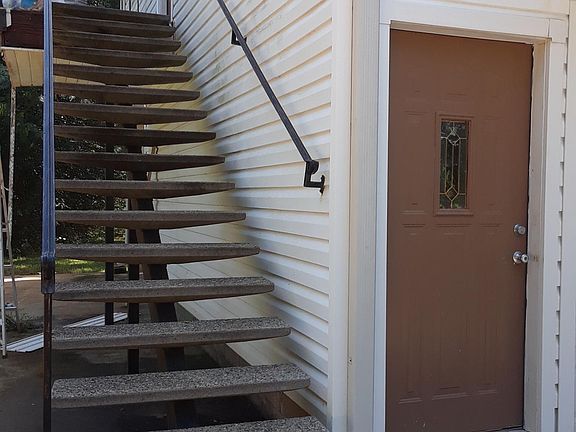 Pebble finish concrete stairs to front door .