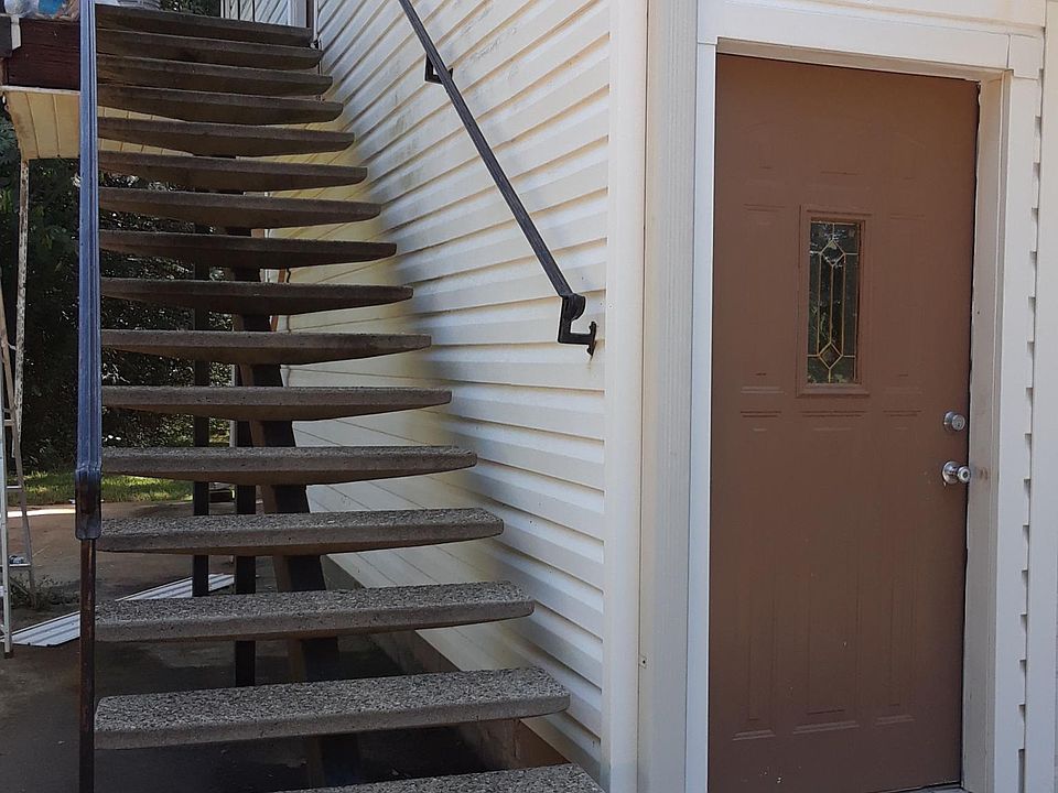Pebble finish concrete stairs to front door .
