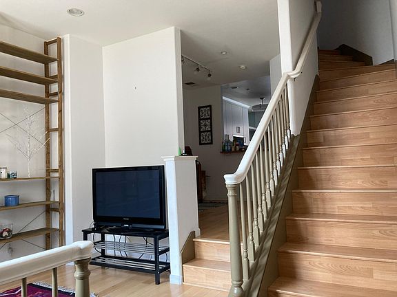 Living room and dining area, with kitchen in the distance.