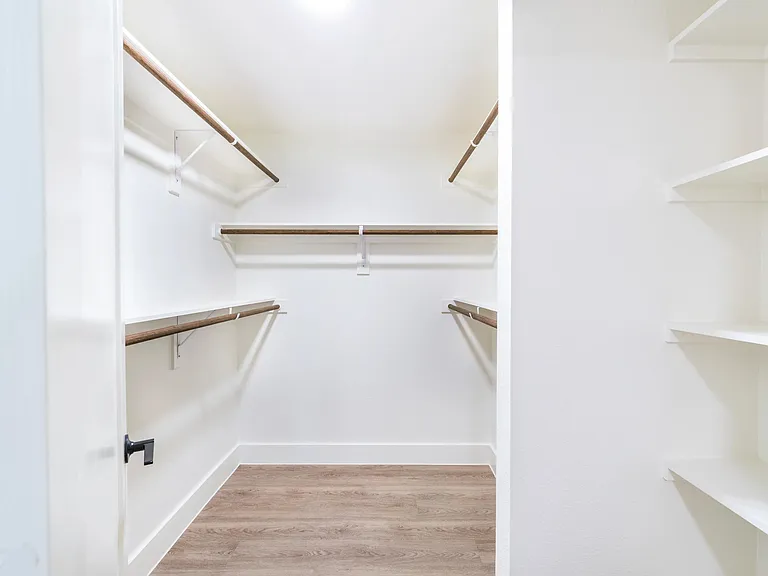 Generous closet space designed to keep your wardrobe beautifully organized and easily accessible.