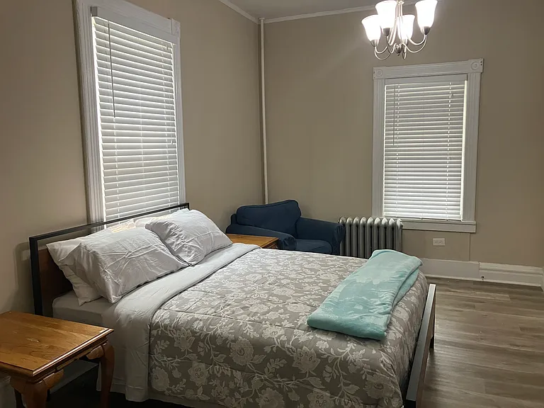 Large, fully furnished first bedroom that could be used as an office or den.