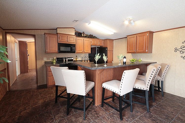 The kitchen features an island, and plenty of built-in cabin