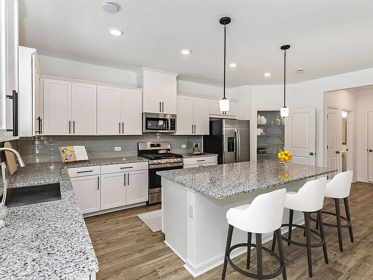 Spacious kitchen with an island, ample storage, and stainless steel appliances.