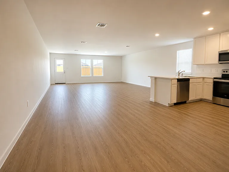 Open concept view of the kitchen and living room with lots of natural light