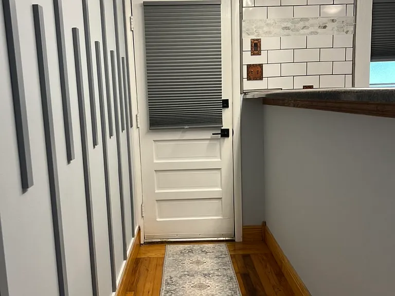 Entry way. Hardwood floors. Black out shades.