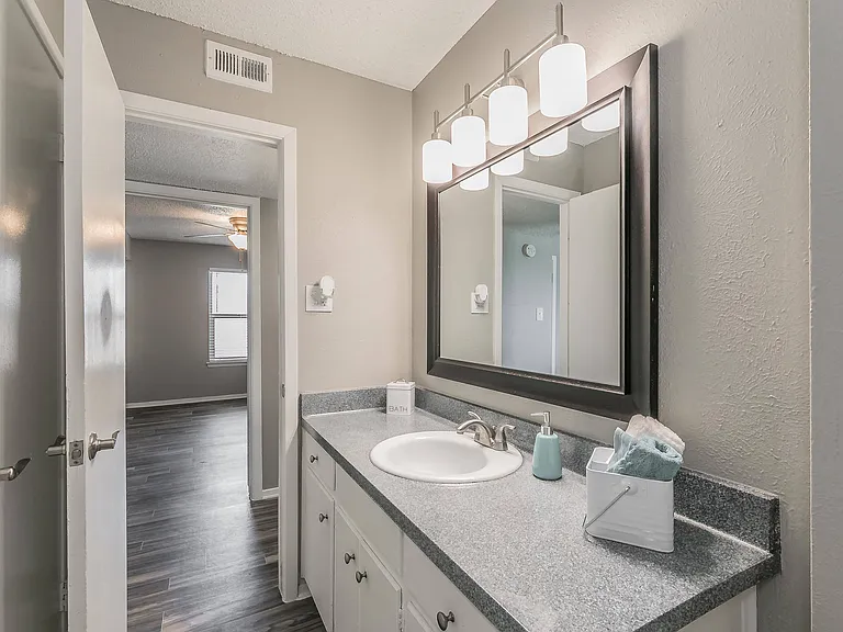 Modern bathroom with bright vanity and large mirror