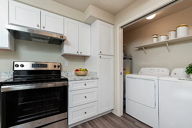 Experience seamless living with this stylish kitchen and convenient laundry setup. Experience seamless living with this stylish kitchen and convenient laundry setup.
