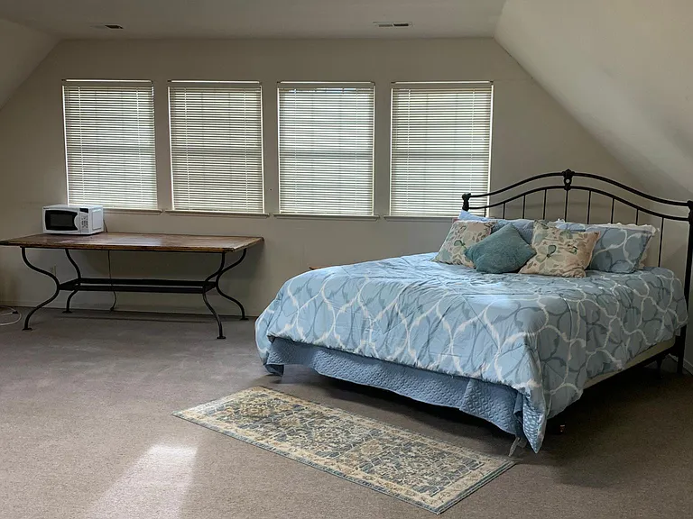 Large 1000 sq ft bonus bedroom partially furnished, with a couch and awesome king-size bed, that goes with the private full bathroom!