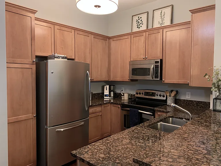 Kitchen with everything you need, including refrigerator and freezer, oven, stove, microwave, and dishwasher