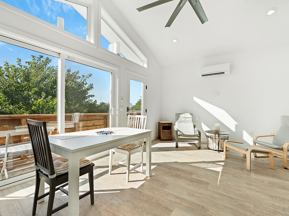 Great room with south facing main windows and glass entry door.