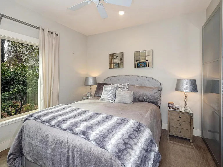 Bedroom with large closet and views of private backyard