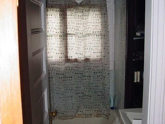 bathroom with tub and shower