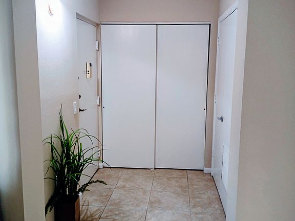 View looking back into the spacious entry that conceals your convenient laundry area.