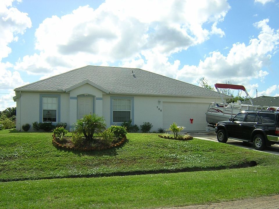 After landscaping, there is another small palm to the left of the picture.