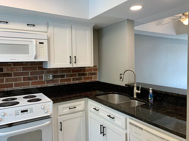 Remodeled kitchen with granite countertops, new cabinets, under-mounted sink and new fixtures.